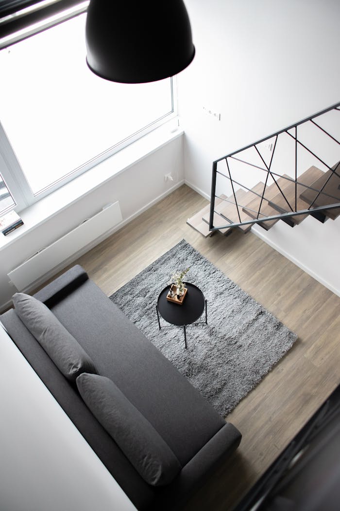 services-01 Aerial view of a stylish minimalist loft with modern furnishings and elegant decor.